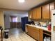 A spacious kitchen area with tile floors, ample cabinetry, and a window view to another room at 3946 W Holly St, Phoenix, AZ 85009