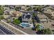 Aerial view of a home with solar panels, a swimming pool, and lush landscaping in a residential neighborhood at 41581 W Somerset Dr, Maricopa, AZ 85138