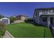Spacious backyard featuring well-manicured lawn and storage shed at 41581 W Somerset Dr, Maricopa, AZ 85138