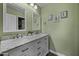 Well-lit bathroom with double vanity, ample storage, and modern decor at 41581 W Somerset Dr, Maricopa, AZ 85138