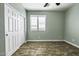 Cozy bedroom with a closet, a window and wood-like floors at 41581 W Somerset Dr, Maricopa, AZ 85138