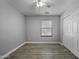 Bedroom featuring a ceiling fan, a window, and wood-look flooring at 41581 W Somerset Dr, Maricopa, AZ 85138