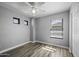 Comfortable bedroom featuring a ceiling fan, two windows, and wood-look flooring at 41581 W Somerset Dr, Maricopa, AZ 85138
