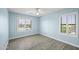 Serene bedroom with blue walls, plantation shutters, and light wood flooring at 41581 W Somerset Dr, Maricopa, AZ 85138
