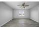 A bedroom is brightened by natural light through a window and is adorned with a ceiling fan at 41581 W Somerset Dr, Maricopa, AZ 85138
