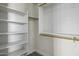 Closet with custom shelves and wood-look floors at 41581 W Somerset Dr, Maricopa, AZ 85138