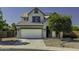 Charming two-story home featuring a large two-car garage and a beautifully landscaped front yard with mature trees at 41581 W Somerset Dr, Maricopa, AZ 85138