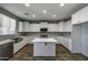 Modern kitchen featuring white cabinetry, stainless steel appliances, and center island at 41581 W Somerset Dr, Maricopa, AZ 85138