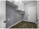 Laundry room featuring storage cabinetry and hard surface floors at 41581 W Somerset Dr, Maricopa, AZ 85138