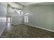 Spacious living room with high ceilings, staircase, modern light fixtures, and stylish wood floors at 41581 W Somerset Dr, Maricopa, AZ 85138