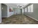 Bright living room with hard surface floors, ceiling fan, and large windows at 41581 W Somerset Dr, Maricopa, AZ 85138
