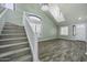 Spacious living room with high ceilings, staircase, modern light fixtures, and stylish wood floors at 41581 W Somerset Dr, Maricopa, AZ 85138