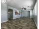 Spacious living room with hard surface floors, fan, and neutral paint palette at 41581 W Somerset Dr, Maricopa, AZ 85138