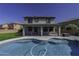 Backyard view of pool and covered patio with solar panels on roof at 41581 W Somerset Dr, Maricopa, AZ 85138