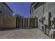 Gated side yard of home with gravel and electrical access at 41581 W Somerset Dr, Maricopa, AZ 85138