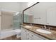 Bathroom with double sinks, granite countertop, bathtub and shower combo at 4208 E Hamblin Dr, Phoenix, AZ 85050