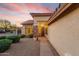 Inviting front entrance with brick accents, desert landscaping, a tile roof, and a covered porch with a lit entryway at 4208 E Hamblin Dr, Phoenix, AZ 85050