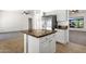 Kitchen island with granite counter tops and stainless steel refrigerator at 4208 E Hamblin Dr, Phoenix, AZ 85050
