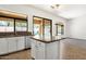 Kitchen island with granite countertop; view to Gathering room and backyard at 4208 E Hamblin Dr, Phoenix, AZ 85050