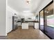Bright kitchen featuring white cabinets, stainless steel appliances, a center island, and tiled flooring and backsplash at 4208 E Hamblin Dr, Phoenix, AZ 85050