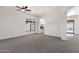 Spacious living room with neutral carpet, bright walls, and views of the outdoor area at 4208 E Hamblin Dr, Phoenix, AZ 85050