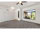 Bright living room featuring a neutral carpet, ceiling fan, a large window, and natural light throughout at 4208 E Hamblin Dr, Phoenix, AZ 85050