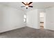 Bright main bedroom featuring neutral carpet, ceiling fan and an ensuite bathroom at 4208 E Hamblin Dr, Phoenix, AZ 85050