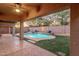 Outdoor patio showcasing a pool with a waterfall feature and artificial turf landscaping at 4208 E Hamblin Dr, Phoenix, AZ 85050