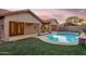 Backyard featuring a pool with artificial grass, creating a relaxing outdoor space at 4208 E Hamblin Dr, Phoenix, AZ 85050
