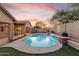 Backyard pool featuring a waterfall, landscaping, and patio at 4208 E Hamblin Dr, Phoenix, AZ 85050