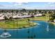 Scenic aerial view of the community featuring a golf course, lake with fountains, and residential areas at 427 S 80Th Way, Mesa, AZ 85208