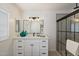 Modern bathroom features a sleek vanity, framed mirror, and walk-in shower with black trim at 427 S 80Th Way, Mesa, AZ 85208