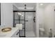 Modern bathroom featuring a stylish vanity, large walk-in shower with black trim, and a toilet at 427 S 80Th Way, Mesa, AZ 85208