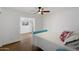 Comfortable bedroom featuring a ceiling fan, and wood-style floors at 427 S 80Th Way, Mesa, AZ 85208