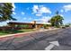 Community clubhouse with desert landscaping and ample parking on a bright, sunny day at 427 S 80Th Way, Mesa, AZ 85208