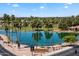 Picturesque view of the Fountain of the Sun community featuring a scenic lake and palm-lined street at 427 S 80Th Way, Mesa, AZ 85208