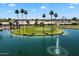 Aerial view of a golf course island with palm trees and a water fountain at 427 S 80Th Way, Mesa, AZ 85208