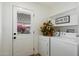 Bright laundry room with white washer and dryer, complemented by decorative accents and natural light at 427 S 80Th Way, Mesa, AZ 85208