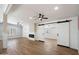 Spacious living area with wood-look floors, a modern fireplace, and sliding barn doors for added privacy at 427 S 80Th Way, Mesa, AZ 85208