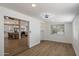 Open-concept area with wood-style flooring, neutral walls, and a glimpse into the kitchen at 427 S 80Th Way, Mesa, AZ 85208