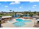 Aerial view of a swimming pool and jacuzzi area surrounded by lush landscaping and amenities at 427 S 80Th Way, Mesa, AZ 85208