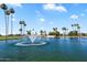 Picturesque lake with a central water fountain surrounded by palm trees at 427 S 80Th Way, Mesa, AZ 85208