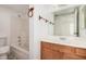 Bright bathroom featuring a tub and shower combination with wood finishings at 4406 E Carter Dr, Phoenix, AZ 85042