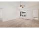 A cozy bedroom with neutral carpet, ceiling fan, and natural light at 4406 E Carter Dr, Phoenix, AZ 85042
