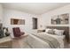 Bright bedroom with a serene aesthetic, featuring a queen-sized bed, plush carpeting, and soft neutral tones at 4406 E Carter Dr, Phoenix, AZ 85042