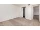 Bright bedroom with plush carpeting and a view into the home at 4406 E Carter Dr, Phoenix, AZ 85042