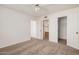 Bedroom features neutral carpeting and doorways leading to the bathroom and closet at 4406 E Carter Dr, Phoenix, AZ 85042