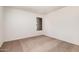 Neutral toned bedroom featuring a window and wall to wall carpeting at 4406 E Carter Dr, Phoenix, AZ 85042