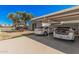 Carport featuring parking for two cars, mature trees, and a well-maintained paved driveway at 4406 E Carter Dr, Phoenix, AZ 85042