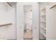 Large walk-in closet featuring built-in shelving and hanging rods at 4406 E Carter Dr, Phoenix, AZ 85042